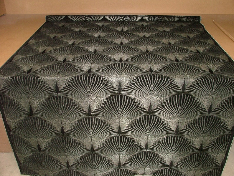 May include: Black fabric with a silver metallic pattern of repeating stylized fans.