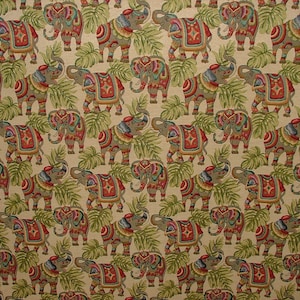 May include: A beige fabric with a repeating pattern of colorful elephants with intricate designs. The elephants are surrounded by green leaves.