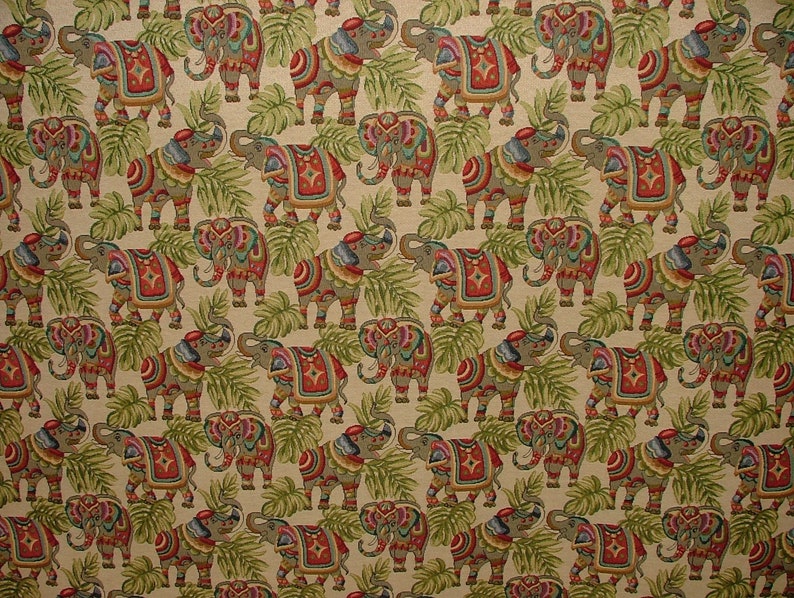 May include: A beige fabric with a repeating pattern of colorful elephants with intricate designs. The elephants are surrounded by green leaves.