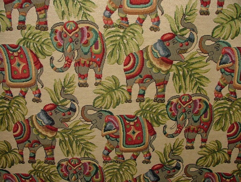 May include: A beige fabric with a repeating pattern of colorful elephants with intricate designs. The elephants are surrounded by green leaves.