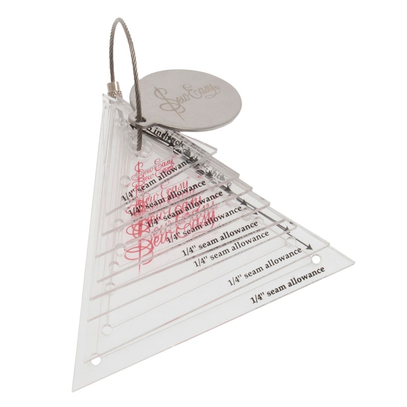 May include: A set of clear plastic triangle rulers with a silver ring and tag that says "Sew Easy". The rulers are marked with "1/4" seam allowance" in red text.