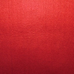 May include: A solid red background with a slightly textured surface.