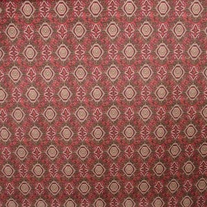 May include: A patterned fabric with a repeating design of diamond and circular shapes in shades of red, brown, and beige. The fabric has a textured appearance, creating a visually rich surface.