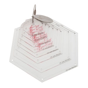 May include: A set of clear plastic hexagon quilting rulers with a 1/4 inch seam allowance. The rulers are nested inside each other and have different sizes, ranging from 1 inch to 3 inches. The rulers are labelled "Sew Easy" and have a silver ring for hanging.