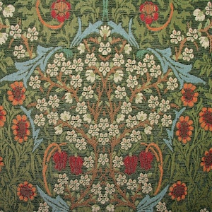 May include: Close-up of a green floral pattern featuring white blossoms, orange flowers, and red accents. The design includes stylized leaves in blue and orange, creating a tapestry-like appearance. The overall theme is a botanical design.