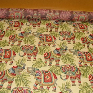 May include: A tapestry fabric with a repeating pattern of colorful elephants in a jungle setting. The elephants are decorated with intricate designs and are surrounded by green leaves.