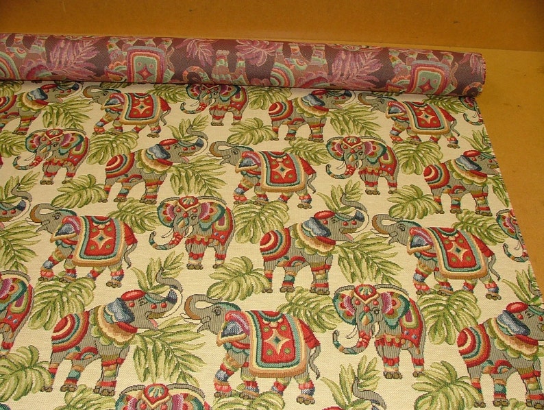 May include: A tapestry fabric with a repeating pattern of colorful elephants in a jungle setting. The elephants are decorated with intricate designs and are surrounded by green leaves.