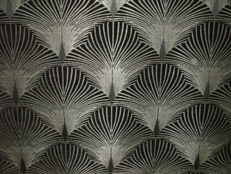 May include: A black fabric with a silver metallic pattern of repeating fan shapes.
