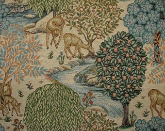 May include: A tapestry featuring a woodland scene with deer, trees, and a stream. The tapestry is woven with a variety of colors, including green, brown, blue, and white.