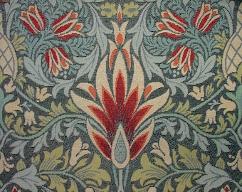 May include: Close-up of a floral pattern textile. The design features stylized red and orange flowers, green leaves, and swirling vines against a dark teal background. The pattern is symmetrical and detailed, with a vintage aesthetic.
