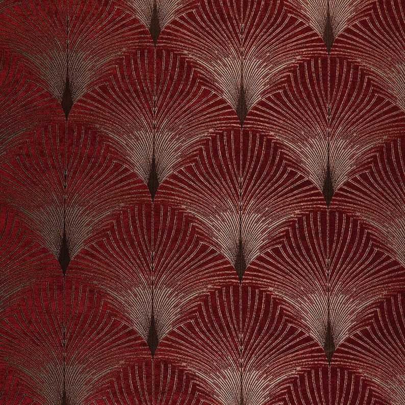 May include: Red fabric with a repeating pattern of gold and black stylized fan shapes.