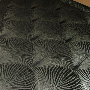 May include: Black fabric with a silver metallic pattern of overlapping fan shapes.