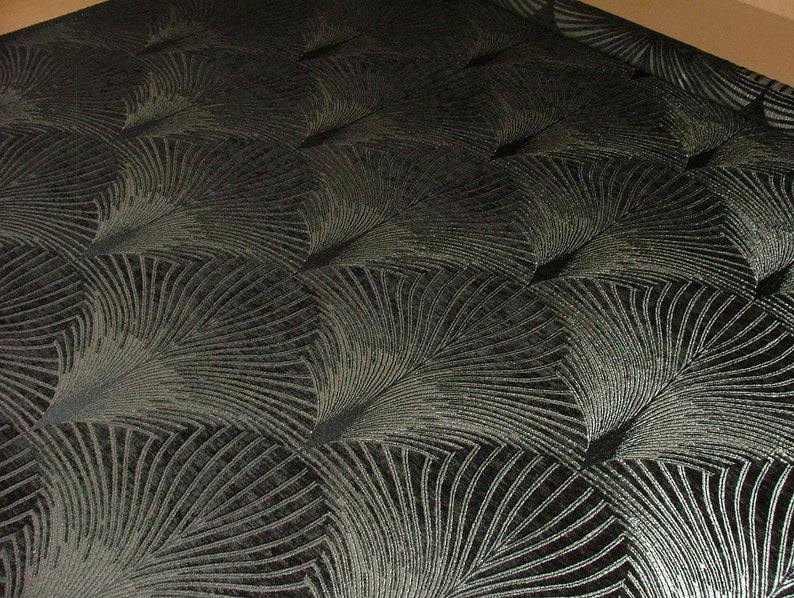May include: Black fabric with a silver metallic pattern of overlapping fan shapes.
