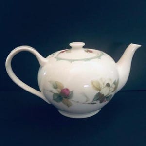 May include: A set of three ceramic mugs with a speckled, matte finish. The mugs are in shades of cream, light gray, and dark gray. Each mug has a simple, minimalist design, perfect for coffee or tea.