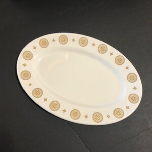 May include: White oval serving platter with a gold rim and a repeating pattern of gold stars and circles.