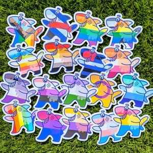 May include: A collection of 18 colorful shark illustrations with various patterns and designs. Each shark is unique and features different colors, including blue, green, red, yellow, and black.