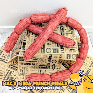 May include: A set of plush red hot dog toys arranged on a brown and white patterned paper with the text "Mac's Mega Munch Meals Only Available From Sharkeroni".
