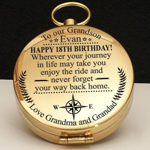 May include: Gold compass with a personalized message for a grandson's 18th birthday. The compass features the text "To our Grandson ☆☆Evan☆☆ HAPPY 18TH BIRTHDAY! Wherever your journey in life may take you enjoy the ride and never forget your way back home. Love Grandma and Grandad".
