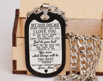 May include: A black dog tag necklace with a silver chain. The dog tag has a message engraved on it that reads "My Son Oscar Never Forget How Much I Love You As You Grow Older You Will Face Many Challenges In Life Just Do Your Best I Might Not Be With You But Know That I Believe In You You Were And Always Will Be The Best Thing That Ever Happened To Me Love, Mom".