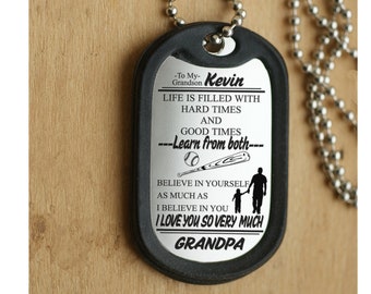 May include: Silver dog tag necklace with a black chain. The tag has an engraved message that reads "To My Grandson Kevin, Life is filled with hard times and good times - Learn from both - Believe in yourself as much as I believe in you. I love you so very much, Grandpa."