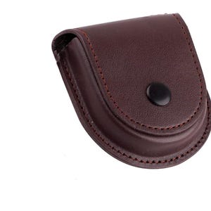 May include: A brown leather coin purse with a snap closure.