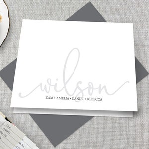May include: White stationery card with a gray envelope. The card has the word "wilson" written in a cursive script in gray. Below the word "wilson" are the names "SAM, AMELIA, DANIEL, REBECCA" in gray.