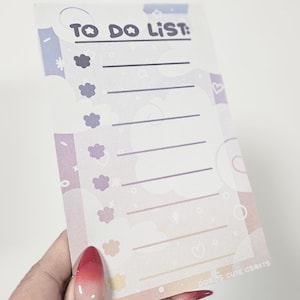 May include: A pastel pink, blue, and yellow to-do list with a white background and a black title that says "TO DO LIST:". The list has 8 lines with a small flower icon next to each line.