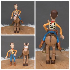 May include: A plastic toy figure of Woody from Toy Story riding a brown horse. Woody is wearing his signature cowboy hat, vest, and jeans. The horse has a brown saddle and bridle.