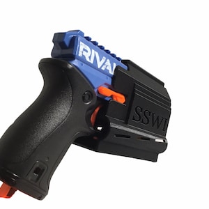 May include: A blue and black toy gun with the word "RIVAL" printed on the side. The gun has a black grip and a black magazine with the word "SSWI" printed on it.