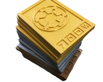May include: A stack of yellow, gray, and brown plastic tiles with a raised Imperial symbol and the word "ZOOM" on the top tile.