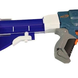 May include: A blue and white Nerf gun with a gray handle and orange accents. The gun features a blue stock and a white attachment. The word "NERF" is visible on the side of the gun.