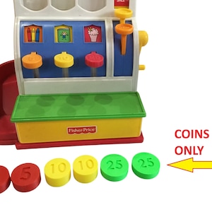 May include: A Fisher-Price toy cash register with a red, yellow, and green color scheme. The register has a drawer that opens and closes, and it comes with five plastic coins: two red 5 cent coins, two yellow 10 cent coins, and one green 25 cent coin. The text "COINS ONLY" is printed on the side of the register.