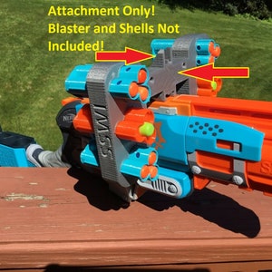 May include: A 3D printed grey attachment for a Nerf Sledgefire blaster. The attachment is a shell holder that can hold six shells. The text "SSMI" is printed on the side of the attachment. The text "Attachment Only! Blaster and Shells Not Included!" is printed on the image.