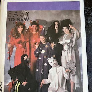 May include: Simplicity sewing pattern featuring Halloween costumes. The pattern includes instructions for creating various costumes, such as a devil, witch, wizard, and ninja. The package is purple and white with the text "EASY TO SEW".