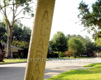 Photograph of the W ALABAMA Street cement street sign in Houston, Texas