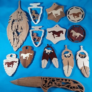 May include: A collection of wooden horse ornaments in various shapes and sizes, including a feather, arrowhead, and star. The ornaments are made of light and dark wood and feature intricate carvings of horses.