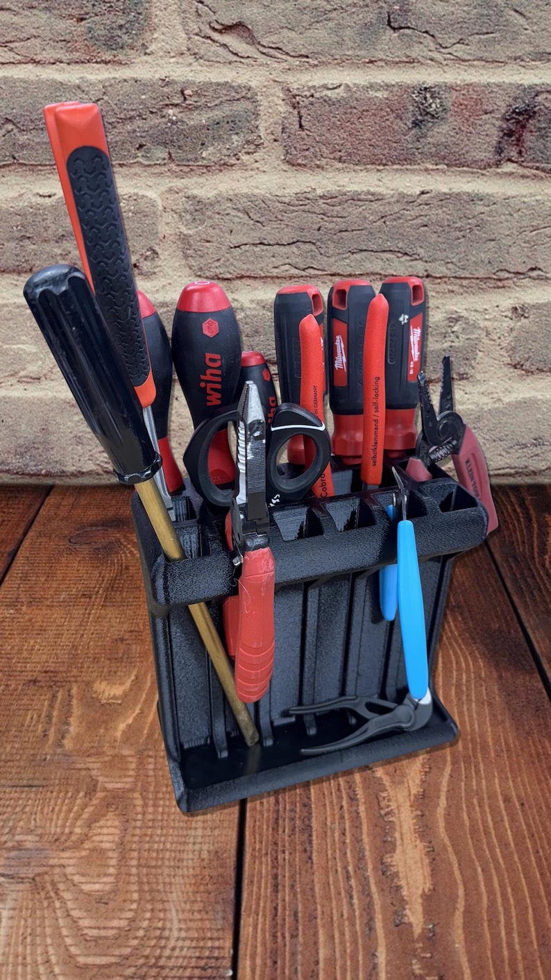 3D printed tool organizer with 16 slots, including extra-wide ones, for screwdrivers, pliers, wrenches, and more. Keeps tools organized and easily accessible.