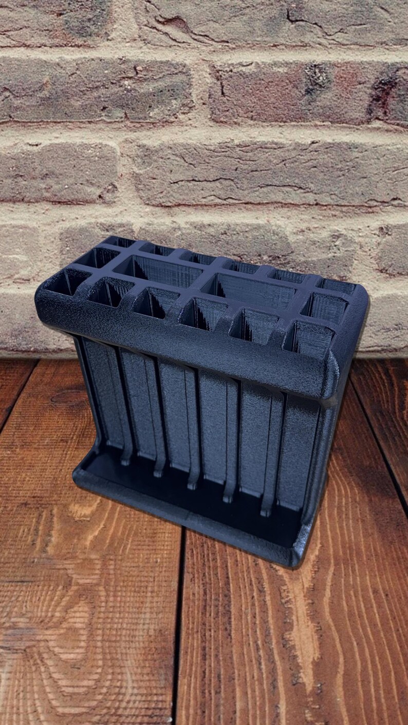 3D printed tool organizer with 16 slots, including extra-wide ones, for screwdrivers, pliers, wrenches, and more. Keeps tools organized and easily accessible.