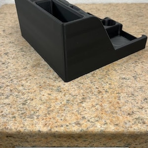 3D printed desk organizer with compartments for tools and supplies.