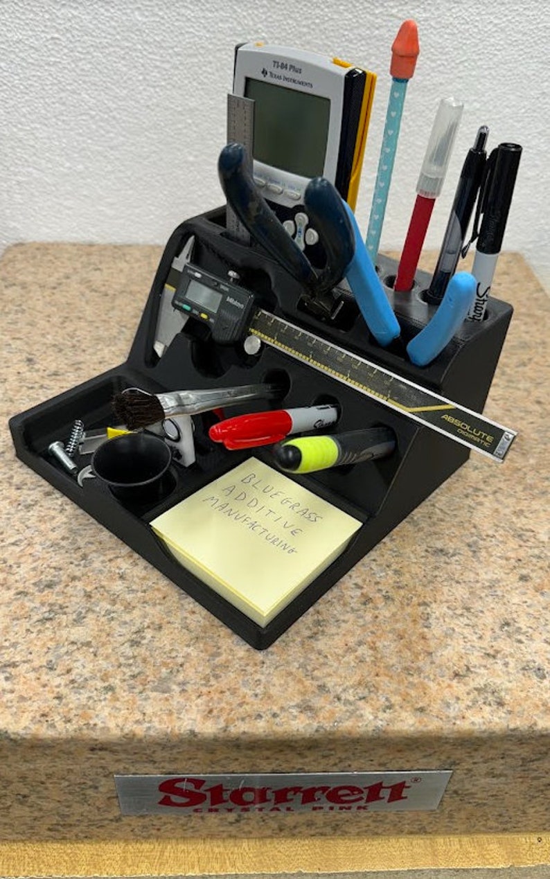 3D printed desk organizer with compartments for tools and supplies.