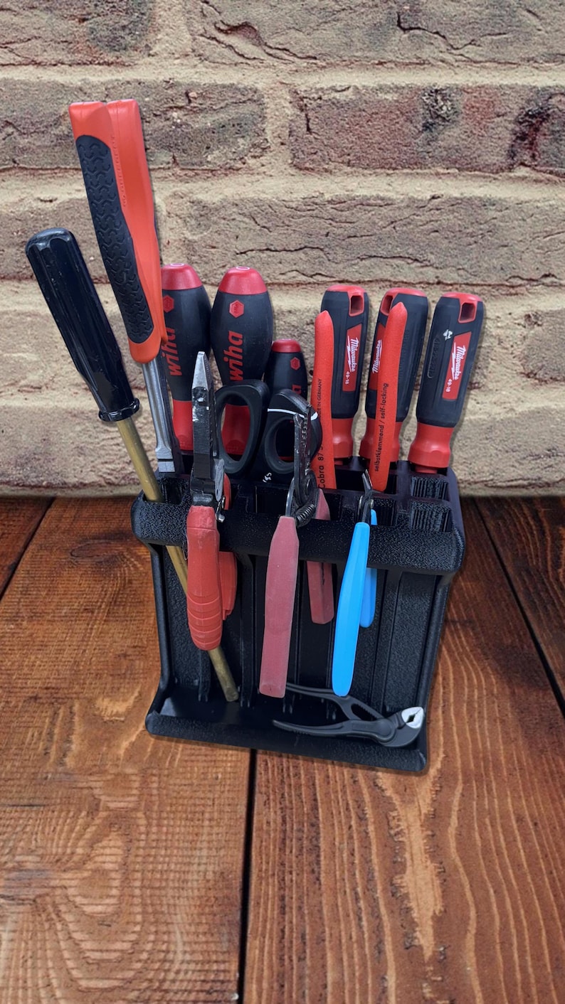 3D printed tool organizer with 16 slots, including extra-wide ones, for screwdrivers, pliers, wrenches, and more. Keeps tools organized and easily accessible.