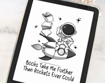 May include: A Kindle e-reader in a clear case. The screen shows a monochrome illustration of an astronaut on a rocket, with books and stars. The text reads "Books Take Me Further Than Rockets Ever Could."