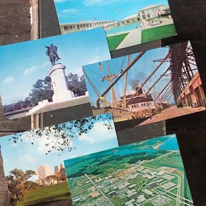 May include: A collection of vintage postcards featuring various scenes, including a statue of a man on horseback, a ship docked at a pier, a building with a swimming pool, and an aerial view of a city.