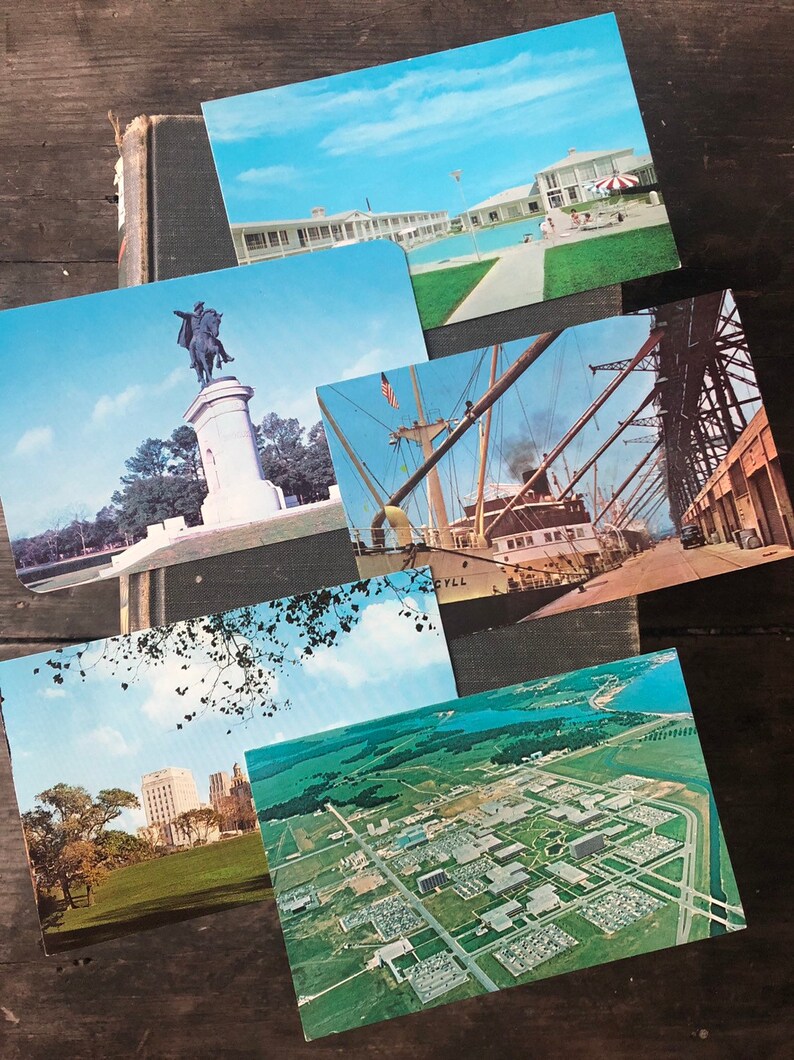 May include: A collection of vintage postcards featuring various scenes, including a statue of a man on horseback, a ship docked at a pier, a building with a swimming pool, and an aerial view of a city.