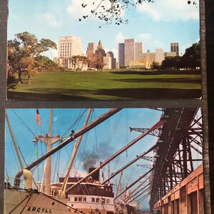 May include: Two vintage postcards. The top postcard shows a cityscape with tall buildings and a grassy park in the foreground. The bottom postcard shows a large cargo ship docked at a port with a metal structure overhead.