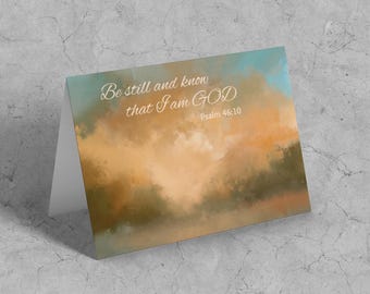 May include: A card with a watercolor background of a sunset with the text "Be still and know that I am GOD Psalm 46:10"