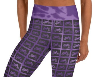 May include: Purple yoga leggings with a repeating pattern of motorcycles in a grid. The leggings have a high waist and a tie-dye effect.