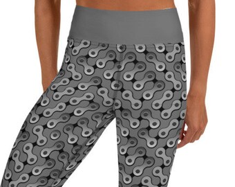 May include: Gray and silver patterned cropped leggings with a high waist. The leggings feature a repeating pattern of interlocking chain links.
