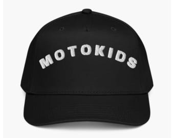 May include: Black baseball cap with the white text "MOTOKIDS" arched across the front. The cap has a curved brim and a button on top. The hat is a classic style, suitable for casual wear.