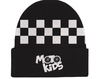 May include: Black beanie with a white checkered pattern and a white logo that says "Moto Kids" with two bicycle wheels.